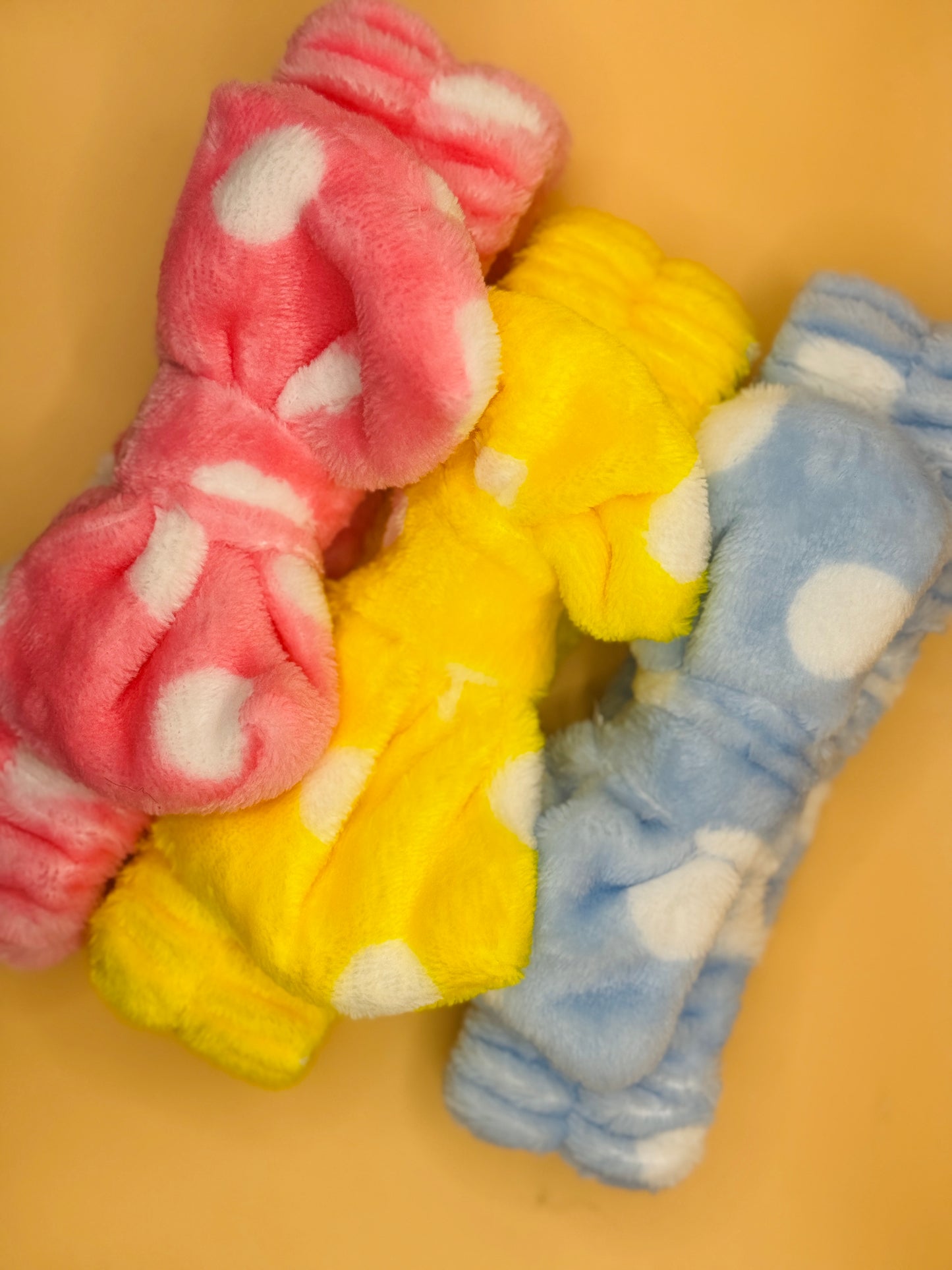 Three colorful spa head band on a beige background