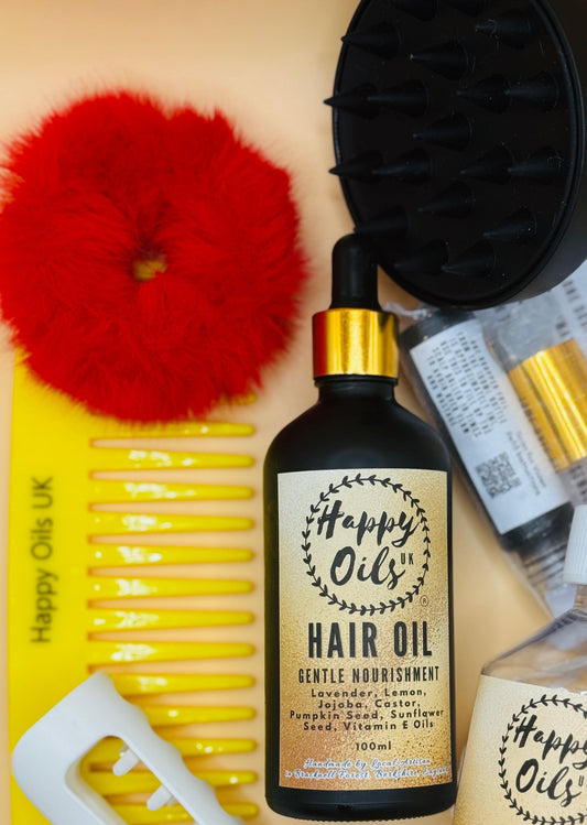 Happy Oils UK hair care products including hair oil, scalp massager, scalp roller hair oil applicator, scrunchie, hair clamp, wide toothed comb on a beige background