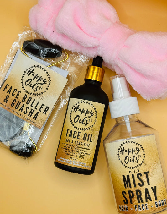 Happy Oils UK face oil, face roller, gua sha, and DIY mist spray bottle on a yellow background